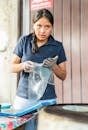 Young Hispanic woman making traditional tortillas indoors, showcasing cultural culinary skills.